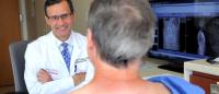 Dr. Lawrence Lenke in consultation with a spine patient.